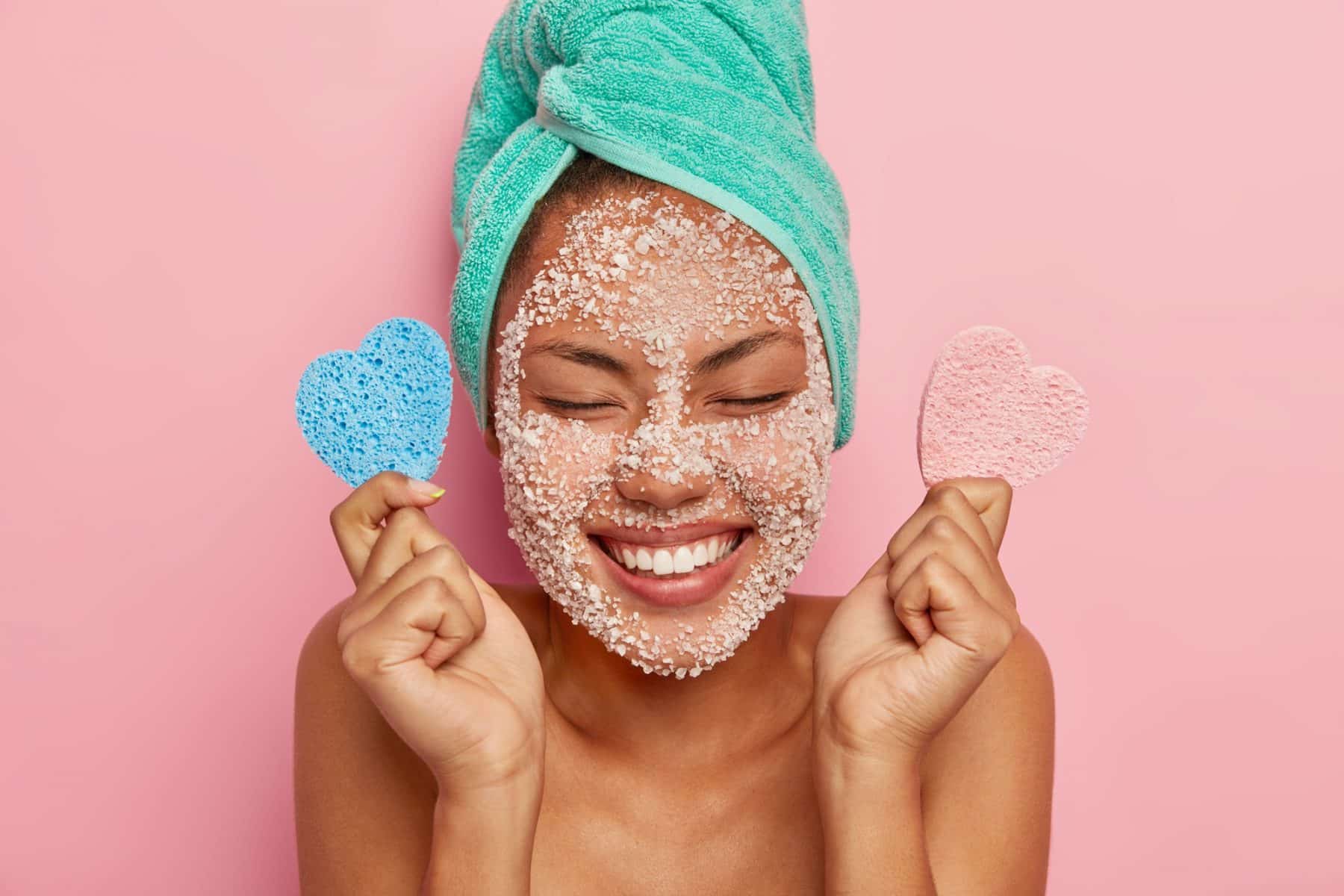 delighted healthy woman laughs sincerely keeps eyes closed shows white perfect teeth has overjoyed face expression applies scrub mask reducing pimples refreshing e1640075527596